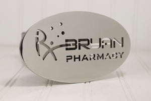 Metallic sign with 'Bryan Pharmacy' logo on a white background