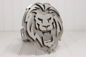 Metallic lion head emblem on a white background